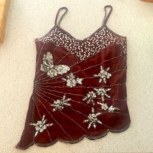 It's a brown mesh top with beaded and butterfly iridescent details.